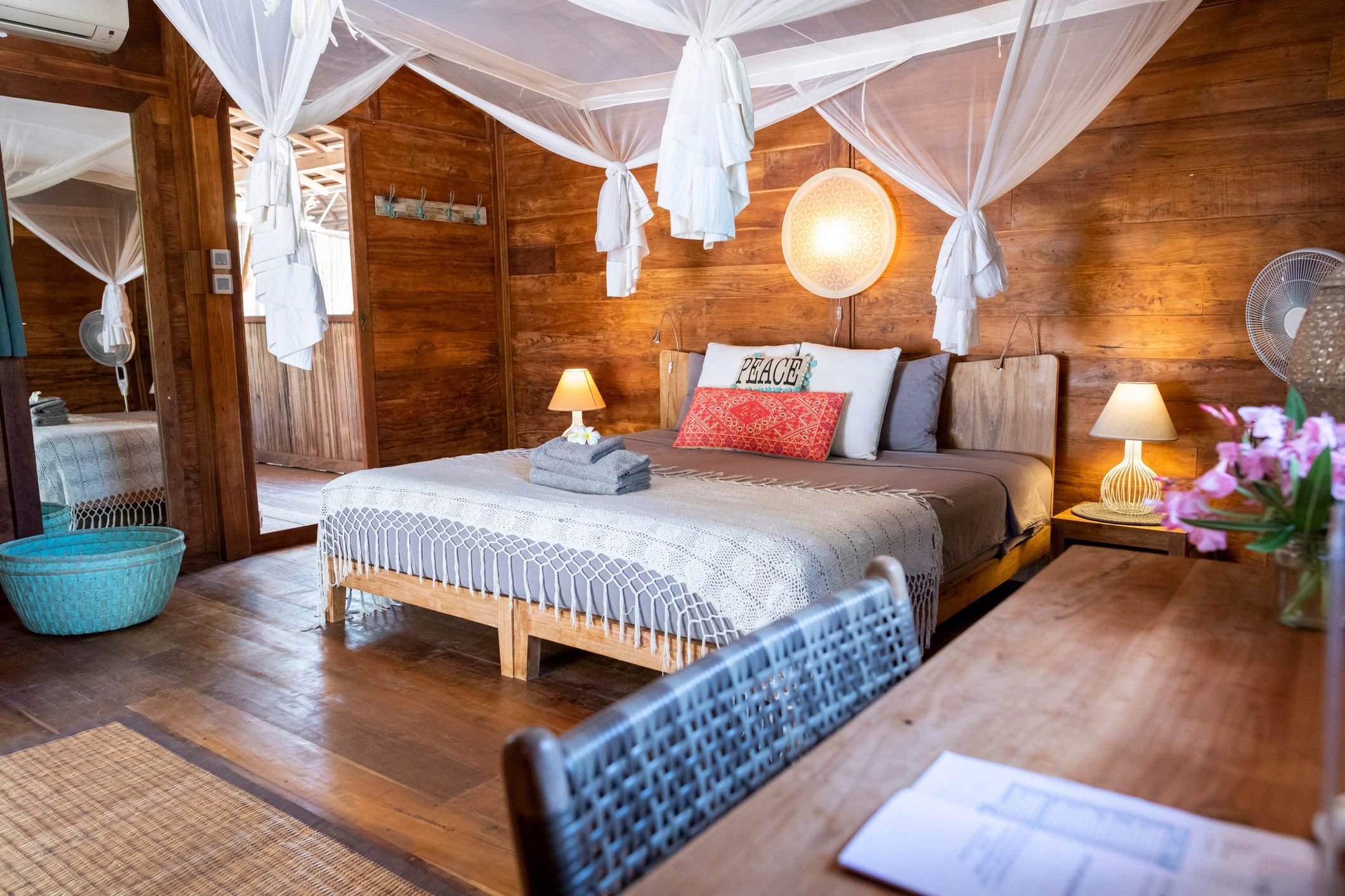 Resort-style room with desk and bed in a natural wood setting