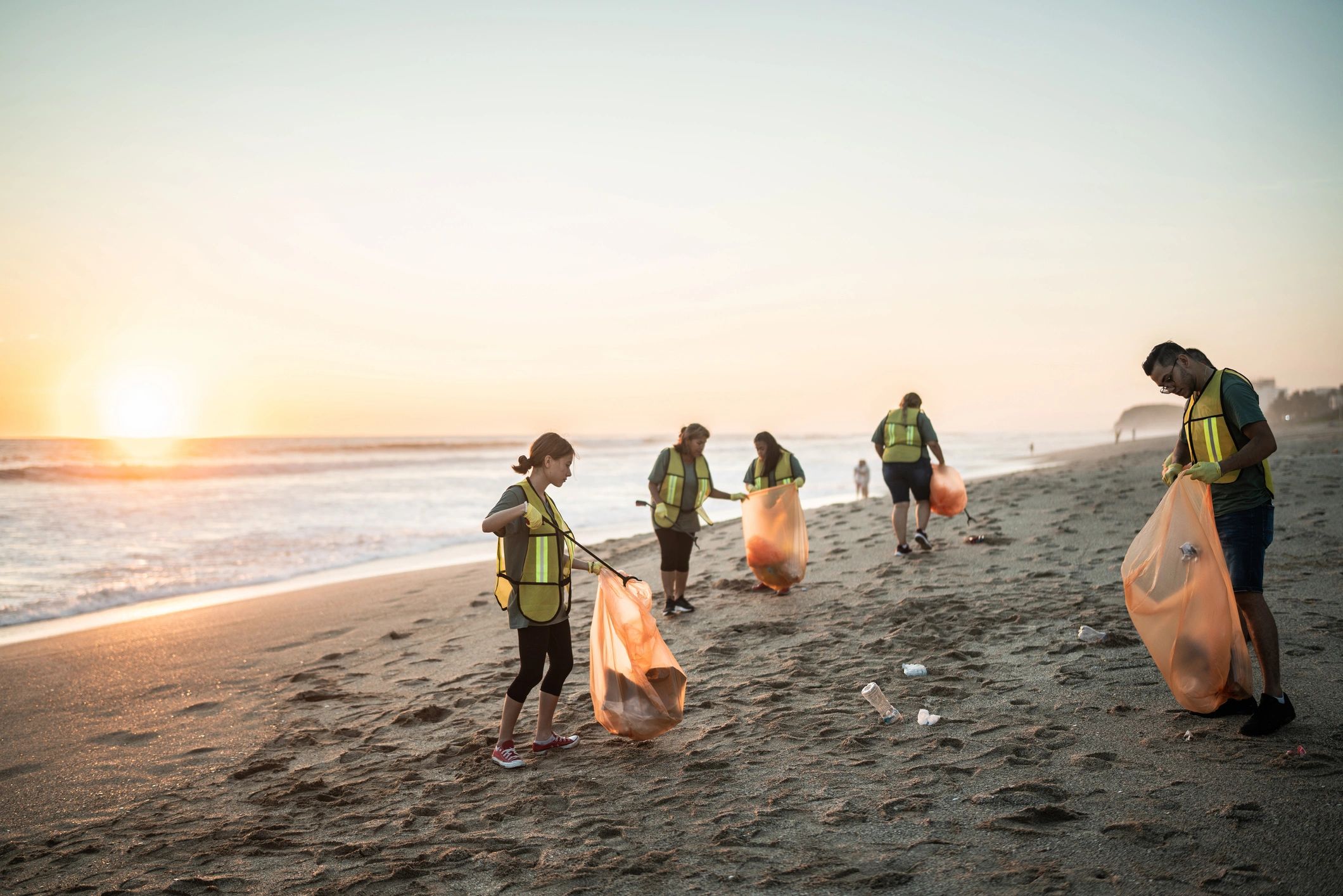 Volunteers cleaning litter from a beach