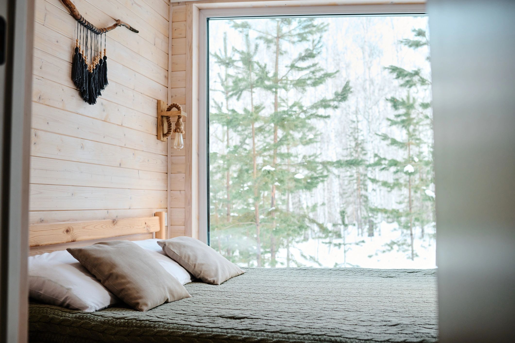 Cozy bedroom interior in a wooden cottage with natural light