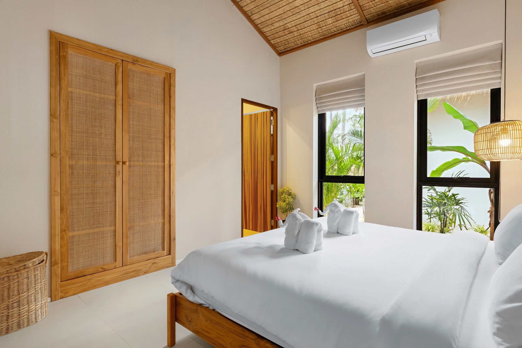 Bright, comfortable guest room with neatly made bed