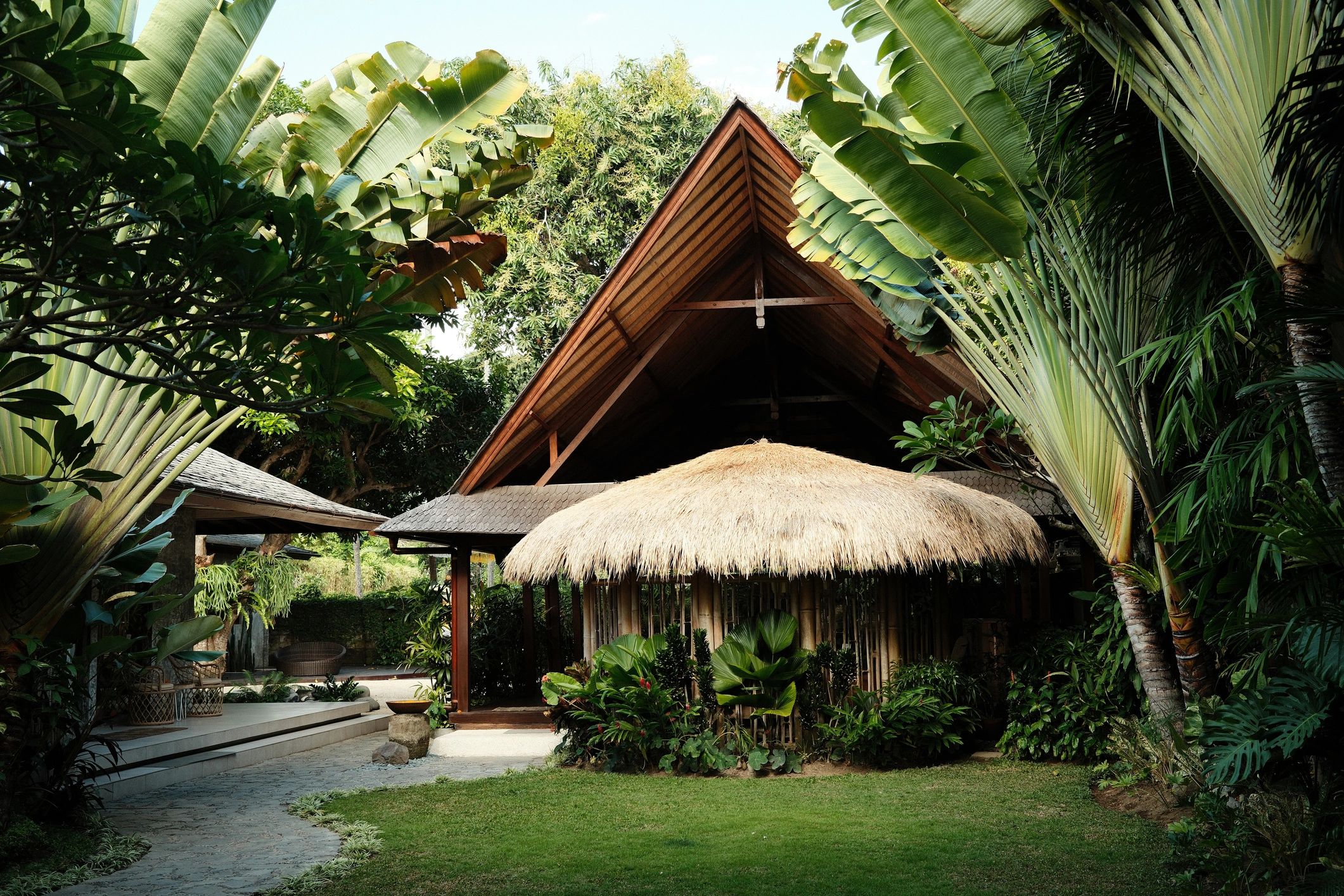 Tropical resort-style bungalow surrounded by lush greenery